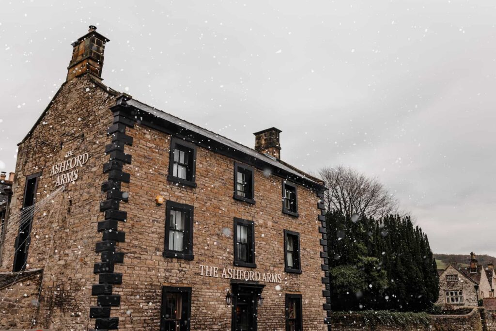 The-Ashford-Arms-Exterior-Christmas-Snow An exterior shot of The Ashford Arms in the winter, with snow falling