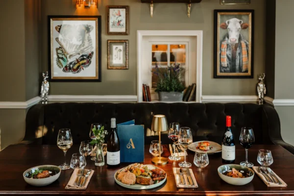 A selection of dishes and wine glasses on a table at The Ashford Arms